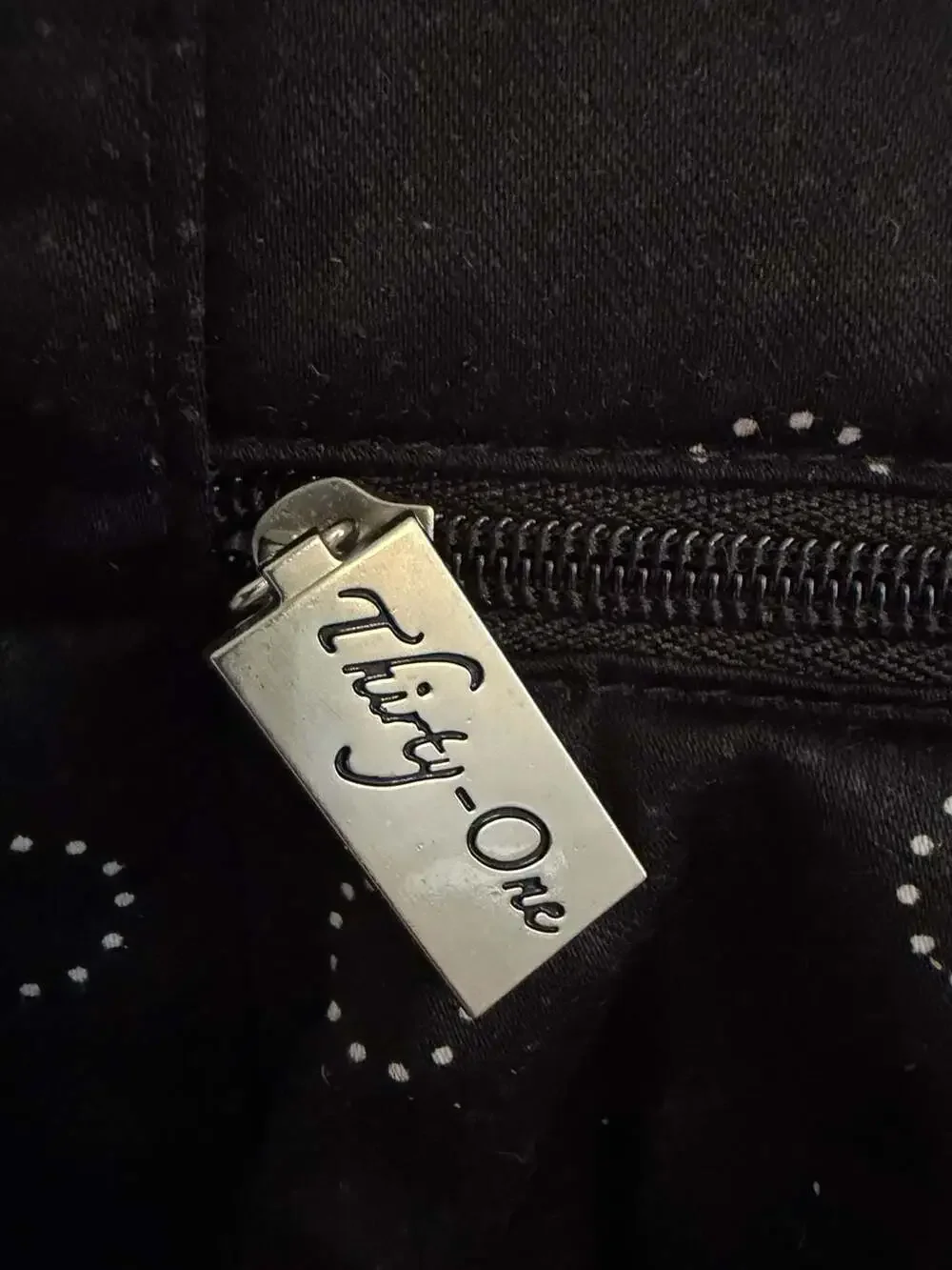 Thirty-One black hobo shoulder bag with white polka dot circles and striped inte